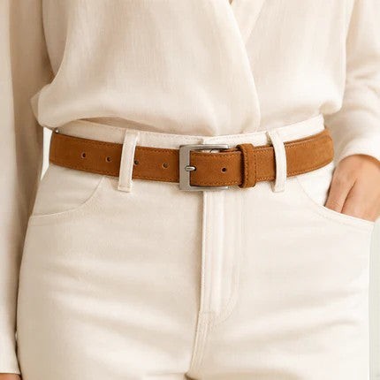 Ceinture La Ceinture Pour Femme Charlotte en daim marron avec boucle ardillon argentée portée sur un jean blanc
